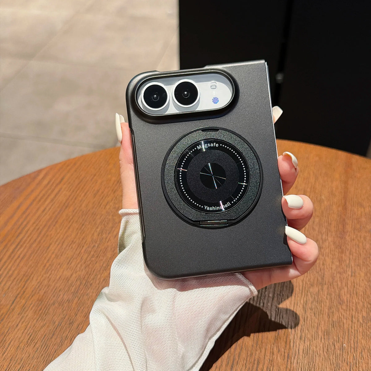 Black armour kickstand case held in hand, back view