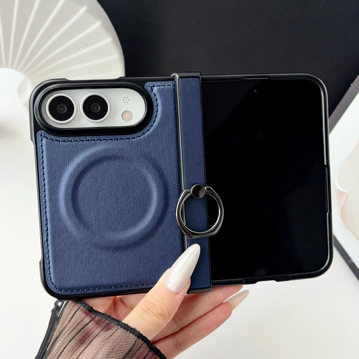 Navy leather-look MagSafe case on an open iPhone Duo, twin rear lenses and magnet ring