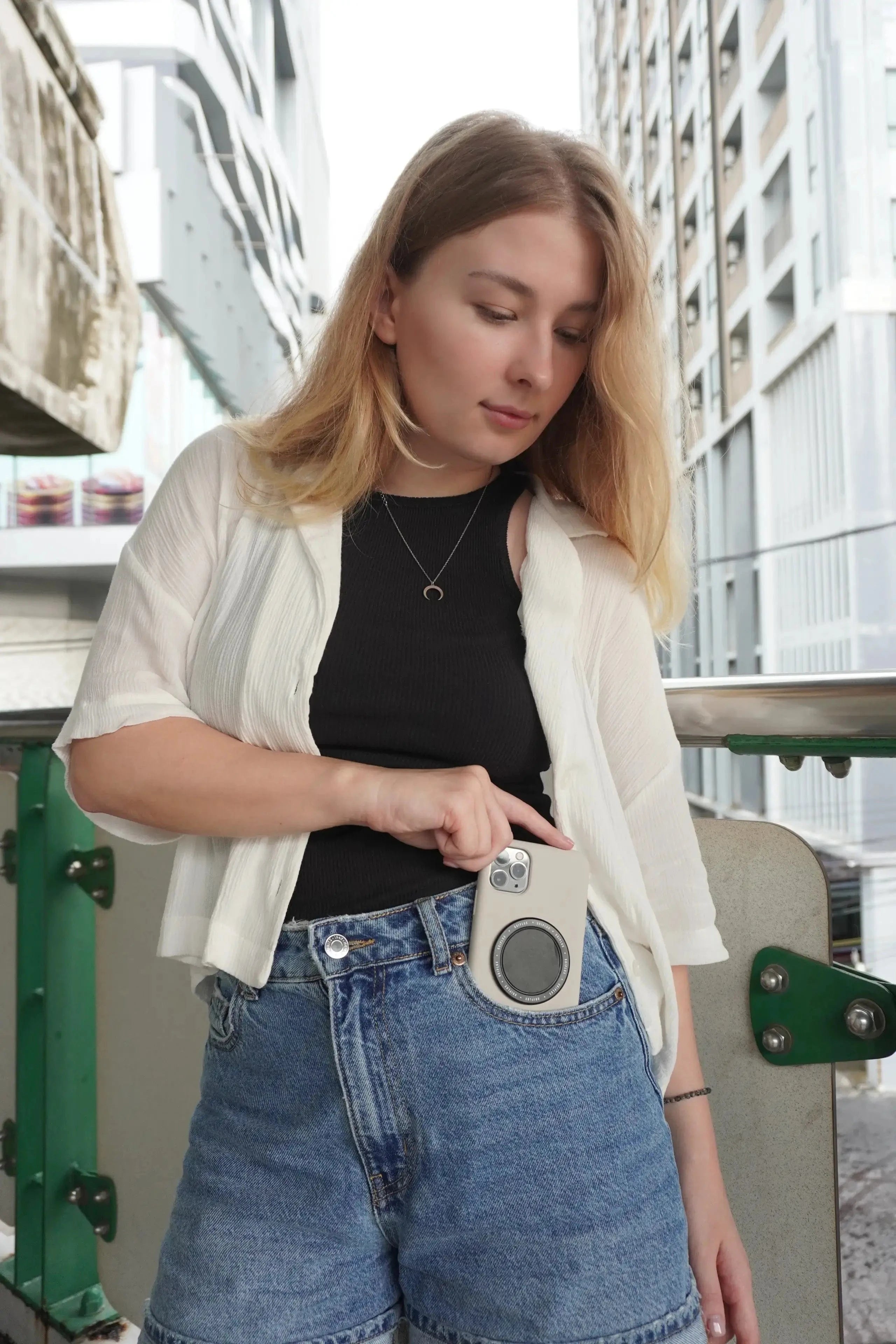 Woman using iPhone with MagSafe Luxi Snap Grip