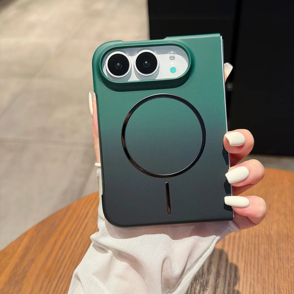 Green slim matte MagSafe case for iPhone Duo, back view in hand