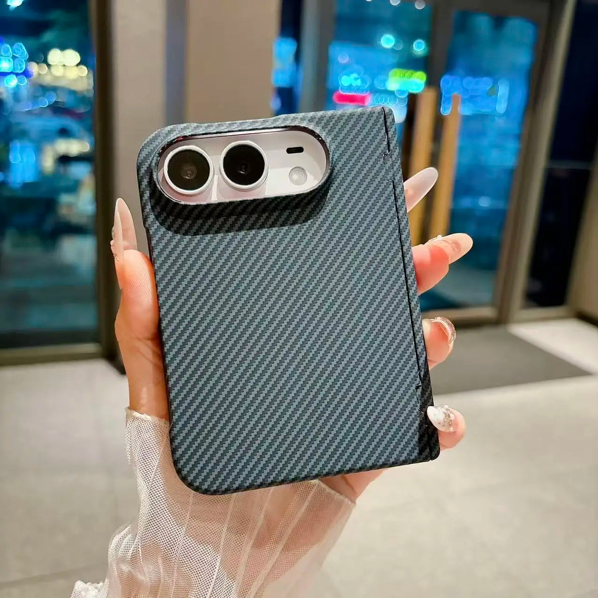 Aramid fibre MagSafe case on a closed iPhone Duo, dark twill weave